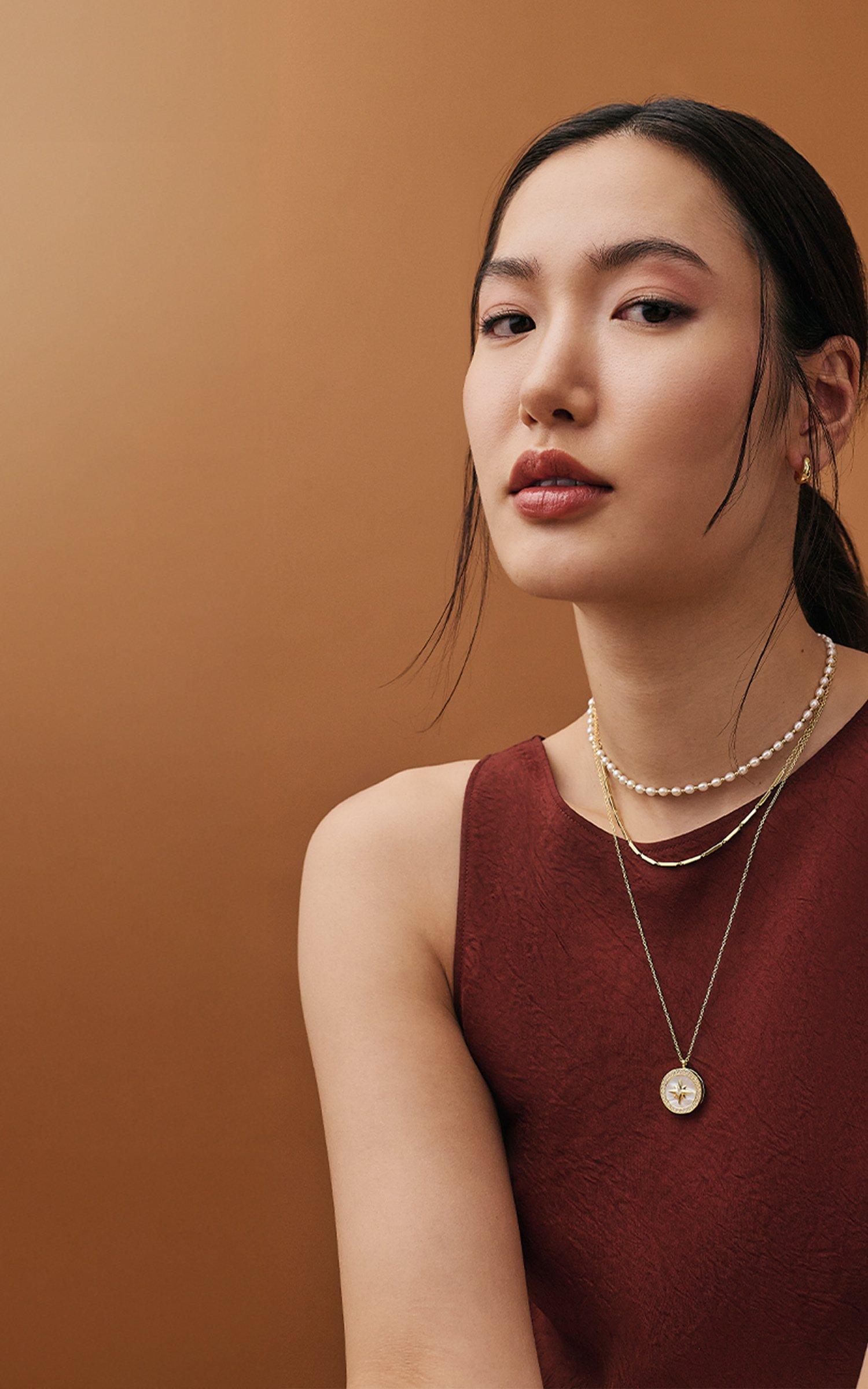 Woman wearing Astley Clarke jewellery